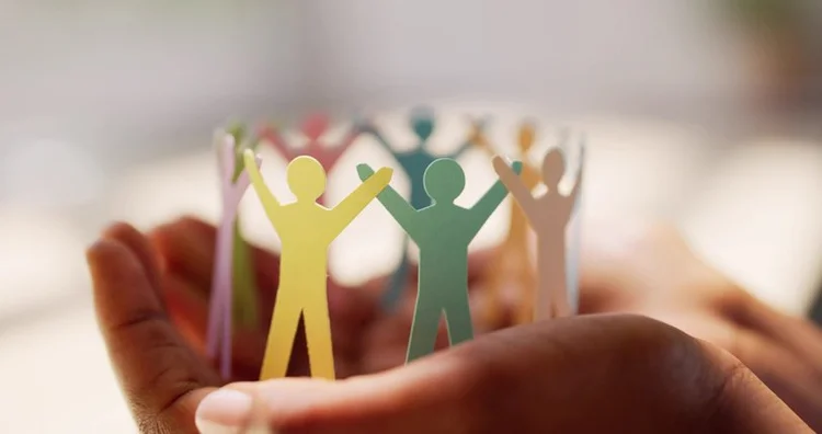 A group of people joining hands